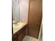 Bathroom featuring a tile floor, light countertops, and a light wood door at 1868 S Ammons St # D, Lakewood, CO 80232