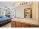 Well-lit bathroom with large mirror, vanity, and easy access to laundry room at 1868 S Ammons St # D, Lakewood, CO 80232