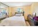 Cozy bedroom with ample natural light, neutral walls, and a large mirrored closet at 1868 S Ammons St # D, Lakewood, CO 80232