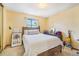 A well-lit bedroom showcases a comfortable bed and ample natural light from the nearby window at 1868 S Ammons St # D, Lakewood, CO 80232