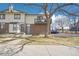 Two-story townhouse with brick facade, balcony, lawn, and convenient parking at 1868 S Ammons St # D, Lakewood, CO 80232