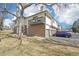 Side view of townhouses with balconies, garage doors, and parking spots at 1868 S Ammons St # D, Lakewood, CO 80232