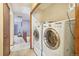 A laundry room featuring modern, full-size washer and dryer units on the second floor at 1868 S Ammons St # D, Lakewood, CO 80232