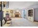 Inviting living room with fireplace, shelving unit, and sliding door access to balcony at 1868 S Ammons St # D, Lakewood, CO 80232