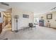 Open living room featuring carpeted flooring, a bar area and natural light at 1868 S Ammons St # D, Lakewood, CO 80232