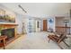 Spacious living room featuring fireplace, balcony access, and stylish décor at 1868 S Ammons St # D, Lakewood, CO 80232