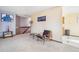Carpeted loft area with stylish seating and views of the kitchen and stairs at 1868 S Ammons St # D, Lakewood, CO 80232