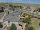 An aerial view shows the home's location in a neighborhood with mature landscaping and green space beyond at 973 Orion Way, Castle Rock, CO 80108