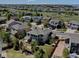 An aerial view looking toward the home, highlighting the backyard patio, and neighborhood with mountain views beyond at 973 Orion Way, Castle Rock, CO 80108