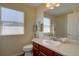 Well-lit bathroom featuring a single sink vanity, toilet, and shower-tub combo at 973 Orion Way, Castle Rock, CO 80108