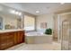 Bright bathroom with a large soaking tub and separate shower stall at 973 Orion Way, Castle Rock, CO 80108