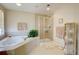 Neutral-toned bathroom featuring a glass-enclosed shower and soaking tub with plant at 973 Orion Way, Castle Rock, CO 80108