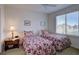 Bright bedroom with twin beds, side table, and window with neighborhood views at 973 Orion Way, Castle Rock, CO 80108