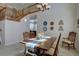 Charming dining area featuring a rustic wood table, unique wall decor, and a view of the staircase at 973 Orion Way, Castle Rock, CO 80108