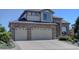 Two-story home with brick exterior, an attached two-car garage, and well-maintained landscaping at 973 Orion Way, Castle Rock, CO 80108
