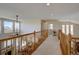 Bright hallway with wood railings overlooks the living room and dining area at 973 Orion Way, Castle Rock, CO 80108