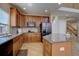 Modern kitchen featuring custom cabinets, granite countertops, stainless steel appliances, and tile flooring at 973 Orion Way, Castle Rock, CO 80108