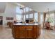 Bright open-concept living area showcasing a large island, floor-to-ceiling windows, and a cozy fireplace at 973 Orion Way, Castle Rock, CO 80108