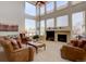 Spacious living room features a fireplace, high ceilings, and an abundance of natural light from large windows at 973 Orion Way, Castle Rock, CO 80108