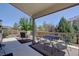 Enjoy the backyard from the covered patio with outdoor seating and a table and chairs at 973 Orion Way, Castle Rock, CO 80108