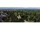 Aerial view of the neighborhood, with the verdant golf course and distant mountains visible on the horizon at 10619 N Osceola Dr, Westminster, CO 80031