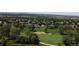 Expansive aerial view of a golf course community with lush green fairways and mature trees, creating a serene residential setting at 10619 N Osceola Dr, Westminster, CO 80031