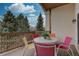 Back deck furnished with a white table and colorful chairs, perfect for outdoor enjoyment at 10619 N Osceola Dr, Westminster, CO 80031