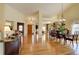 Spacious open-plan with hardwood flooring that seamlessly connects the dining, living, and entryway areas at 10619 N Osceola Dr, Westminster, CO 80031