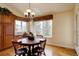 Bright dining room features hardwood floors and an elegant chandelier above a dark-wood table at 10619 N Osceola Dr, Westminster, CO 80031
