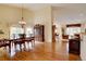 Elegant dining room featuring hardwood floors, a chandelier, and a view into the adjacent living spaces at 10619 N Osceola Dr, Westminster, CO 80031
