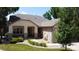Charming home exterior featuring stone accents, a covered porch, a well-maintained lawn, and a peaceful water feature at 10619 N Osceola Dr, Westminster, CO 80031
