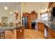 Well-appointed kitchen with hardwood floors, granite countertops, and a breakfast bar next to stainless steel appliances at 10619 N Osceola Dr, Westminster, CO 80031