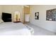 Comfortable main bedroom boasts plush carpet, a ceiling fan, and a view into the bathroom and closet at 10619 N Osceola Dr, Westminster, CO 80031