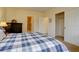 Bright bedroom featuring comfortable bedding, with ensuite bathroom and closet at 10619 N Osceola Dr, Westminster, CO 80031
