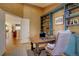 Functional office space with custom built-in shelving and a view into the living room at 10619 N Osceola Dr, Westminster, CO 80031