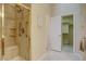 Accessible walk-in shower features tiled walls, a built-in bench, and handrails for added safety at 10619 N Osceola Dr, Westminster, CO 80031