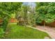 Lush backyard featuring a stone path and a gazebo with mature landscaping at 3613 Julian St, Denver, CO 80211
