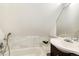 Bathroom with shower/tub combination, marble tile, vanity, and chrome fixtures at 3613 Julian St, Denver, CO 80211