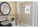 Bathroom with decorative tiles, glass sink, oval mirror and shower over tub at 3613 Julian St, Denver, CO 80211