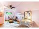 Bright bedroom featuring unique decor, a modern ceiling fan, and a cozy sitting area at 3613 Julian St, Denver, CO 80211