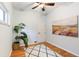 Neutral bedroom features light hardwood floors, a ceiling fan, an area rug, and large art piece at 3613 Julian St, Denver, CO 80211