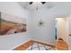 Bright bedroom with wood floors, modern rug, and a large landscape painting for a touch of color and design at 3613 Julian St, Denver, CO 80211