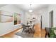 Dining area with modern table and chairs, with a view into the brightly lit kitchen at 3613 Julian St, Denver, CO 80211