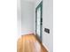 Clean entryway with wood floors and a decorative glass door, with a fresh coat of bright paint at 3613 Julian St, Denver, CO 80211