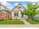 Charming home with a well-maintained lawn, attractive trim, and a cute tree in the front yard at 3613 Julian St, Denver, CO 80211