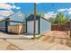 Blue detached garage with white door and wooden fence at 3613 Julian St, Denver, CO 80211