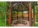 Charming wood gazebo with wood slat seating surrounded by greenery at 3613 Julian St, Denver, CO 80211