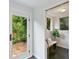 Inviting sunroom featuring a stylish bench and a view to the lush outdoor patio with stone pavers at 3613 Julian St, Denver, CO 80211