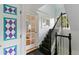 Hallway with a decorative painted door and staircase leading to the upper level of the home at 3613 Julian St, Denver, CO 80211