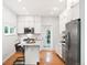 Modern kitchen featuring white cabinets, stainless steel appliances, and a convenient island at 3613 Julian St, Denver, CO 80211